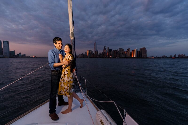 Happy couple on a boat smiling with New York City in the background