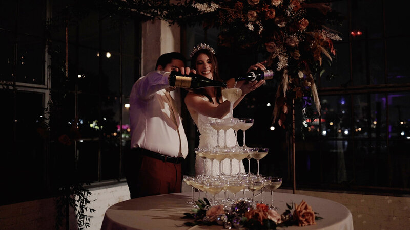Couple pouring a champagne tower