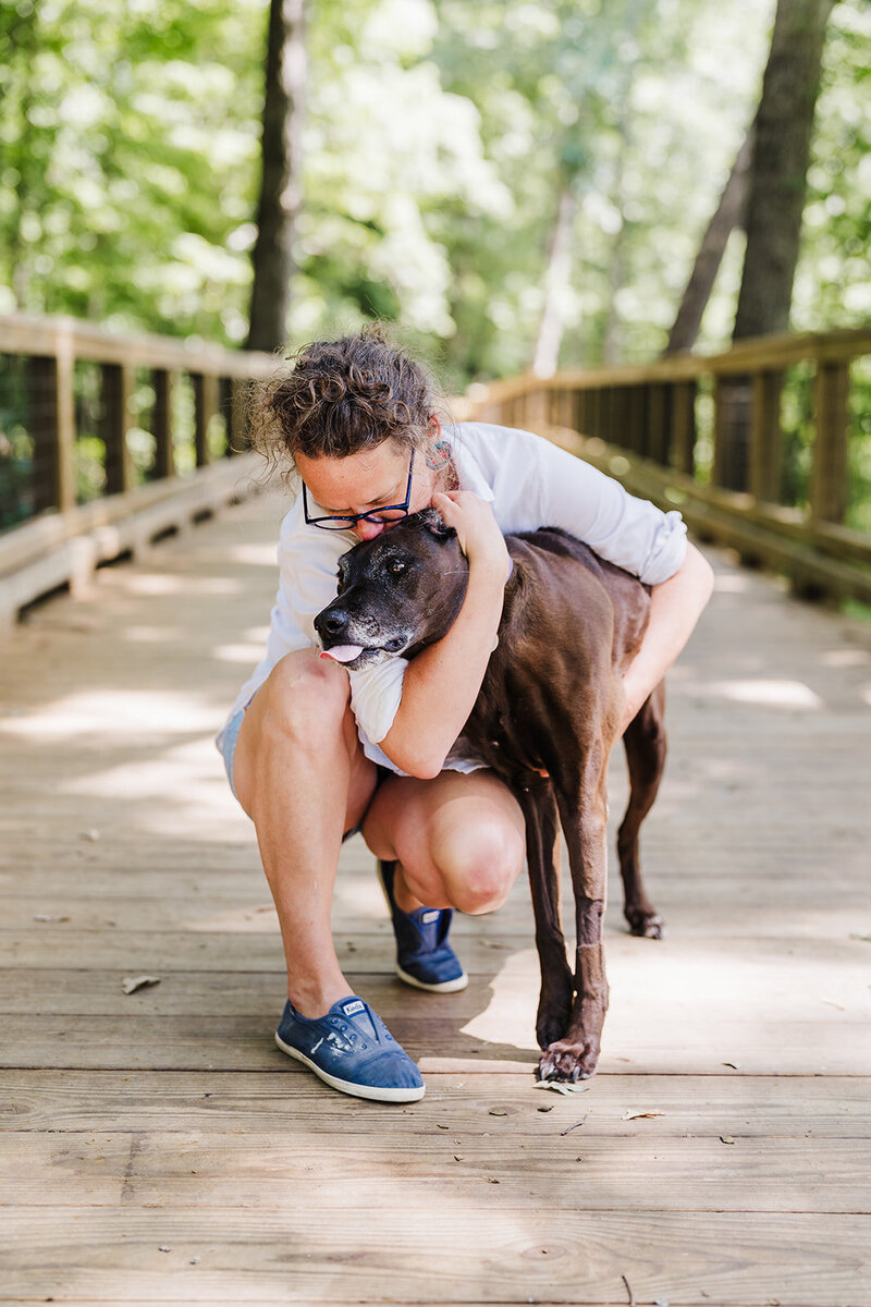 Pet and owner sharing an embrace at the park in Chattanooga, TN