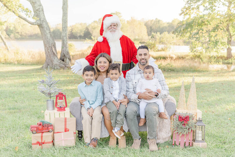 family of 5 posing for a photo with Santa during Northern VA Christmas minis