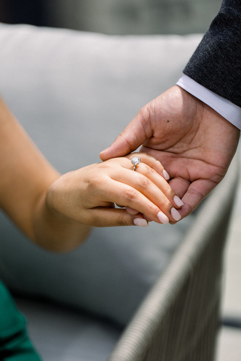 bride and groom holding hands, modeling engagement ring
