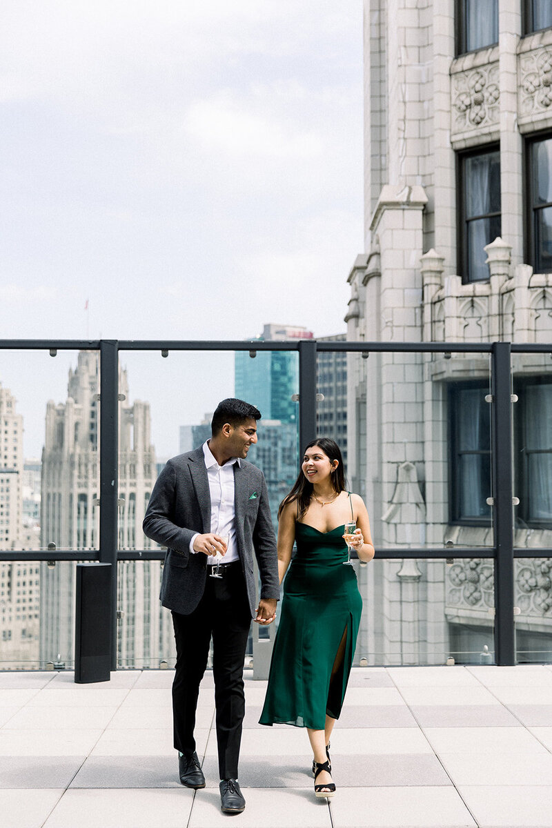 engaged couple walking on chicago rooftop terrace