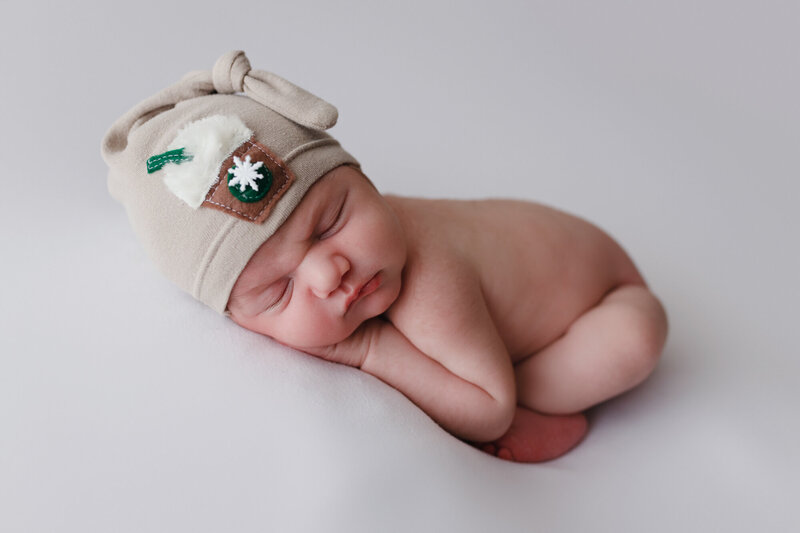 newborn baby posed with little starbucks hat