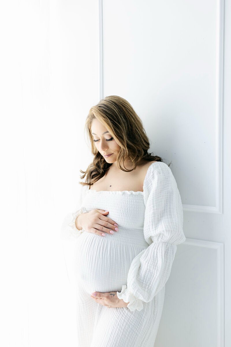 Pregnant mom looking at her baby bump, taken by best maternity photographer nj
