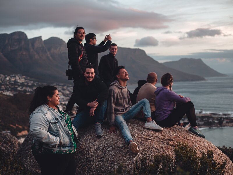 Group of adults supporting each other on a group outing