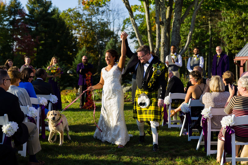 The married couple celebrates as they come back up the aisle after their William Allen Farm wedding in Maine