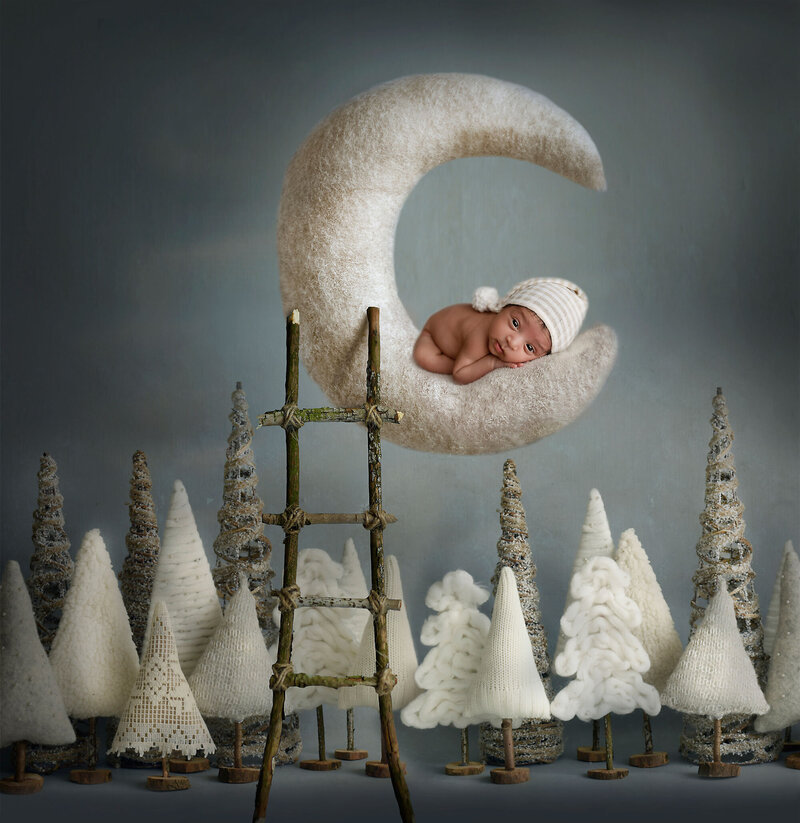 sleepy baby on top of a white moon with a ladder