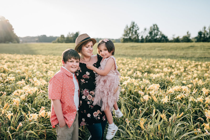 Charlotte wedding photographer living in Dallas, NC with kids in wildflowers in Gastonia, NC