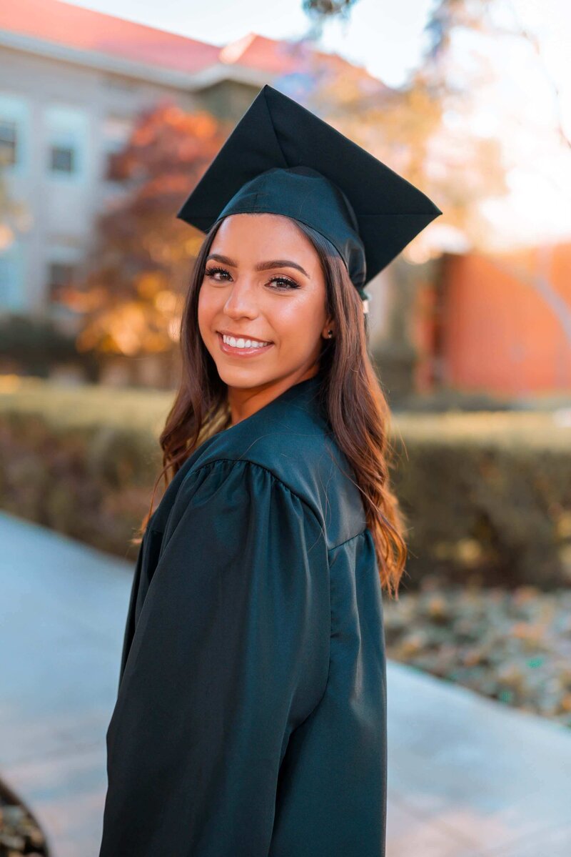 Female college student in graduation cap and gown