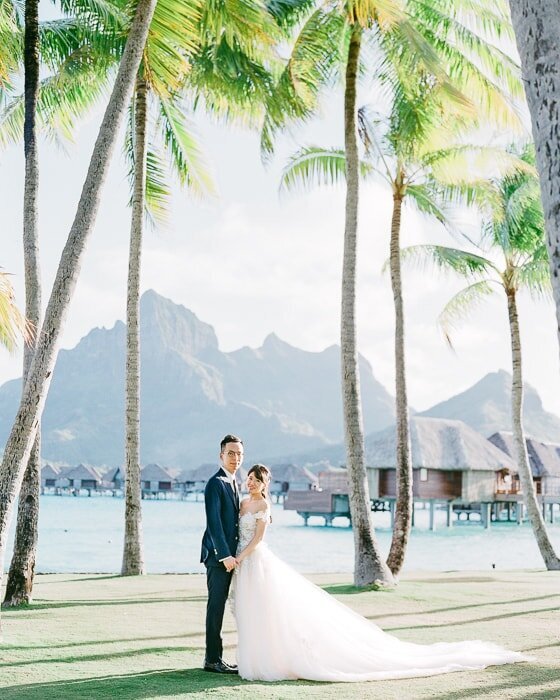 Elegant Wedding at the Four Seasons Resort Bora Bora, bride and groom photoshoot in front of the Mount Otemanu