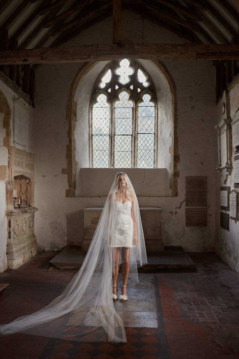Wrap mini wedding dress in silk worn by elegant bride by British designer Luna Bea