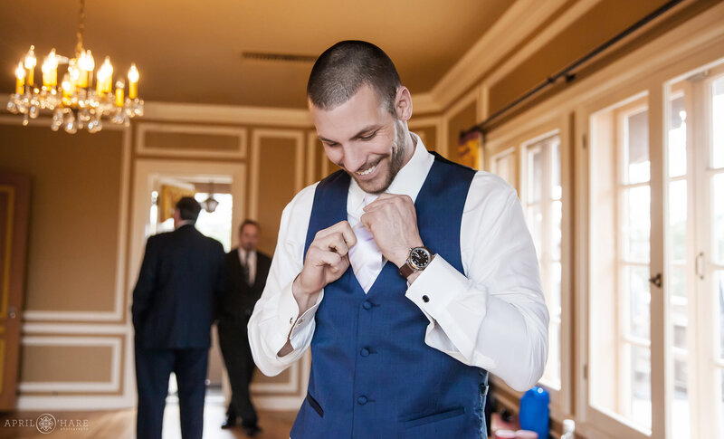 Groom gets ready in the West Bedroom at Highlands Ranch Mansion
