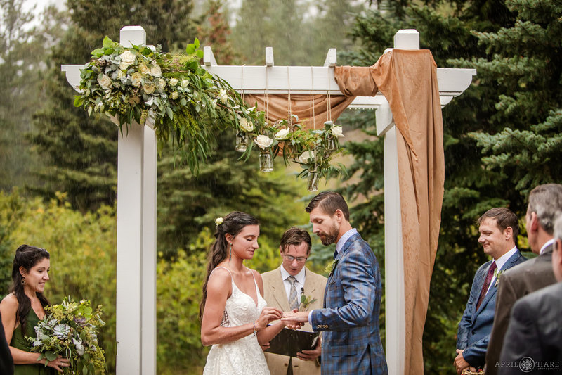 Couple Gets Married Outside in the Pouring Rain at a Rustic Colorado Mountain Wedding Venue