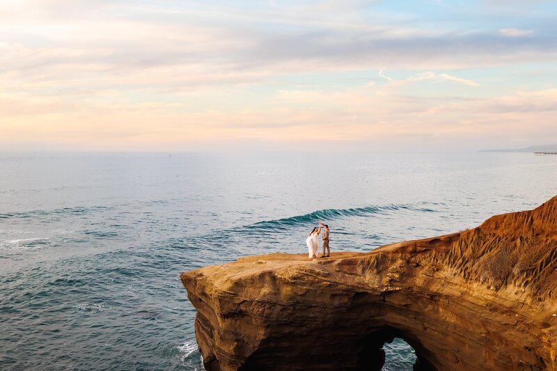 bride and groom dancing at Sunset Cliffs in San Diego, Portrait by Loni Brooke Photography