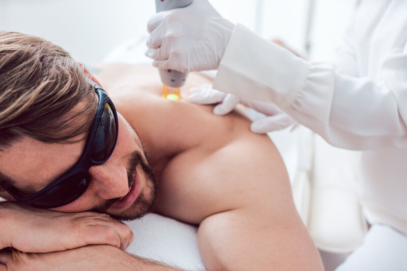 photo of man getting laser treatment