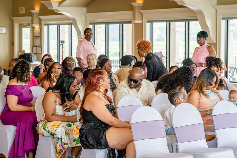 Guests seated during indoor wedding ceremony watching couple – photographed by wedding photographer Niko Coric – Lumen Clarity Media