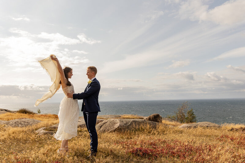Emma and Jack on the rocks enjoying their elopement abroad to Bornholm, where they can get married abroad simply