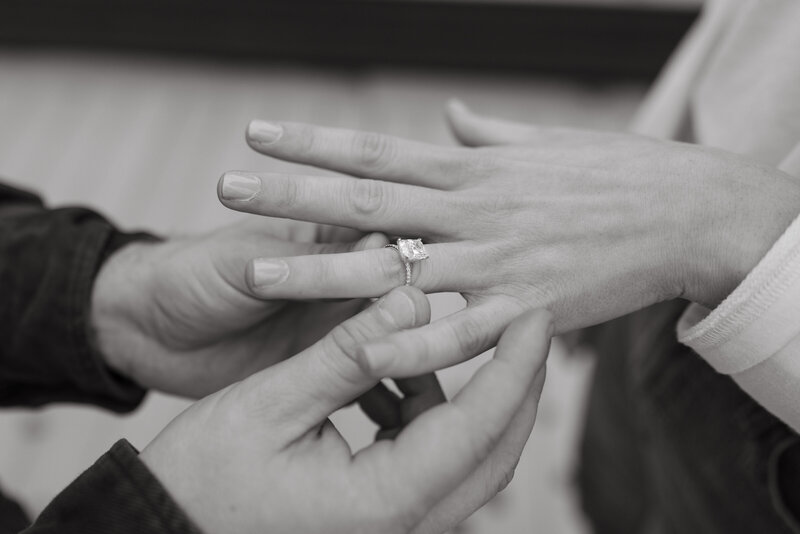 Wedding ring placed on the hand during surprise proposal photography session in fayetteville, Arkansas.