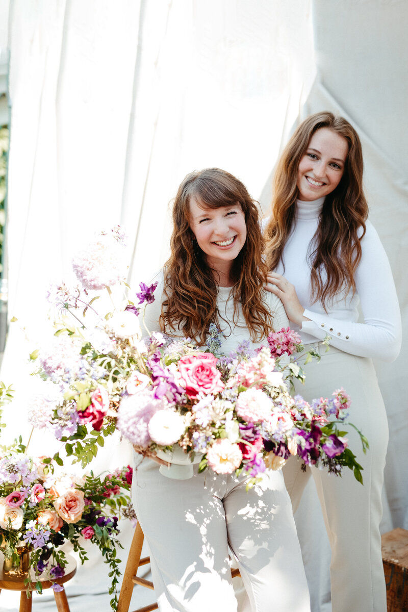 Mary Love and Mackenzie of Rosemary and Finch wedding floral designers, florists, in Nashville, TN. Specialize in large scale weddings, installation, travel weddings, beach, mountain. Floral hues of purple, magenta, and natural greenery.