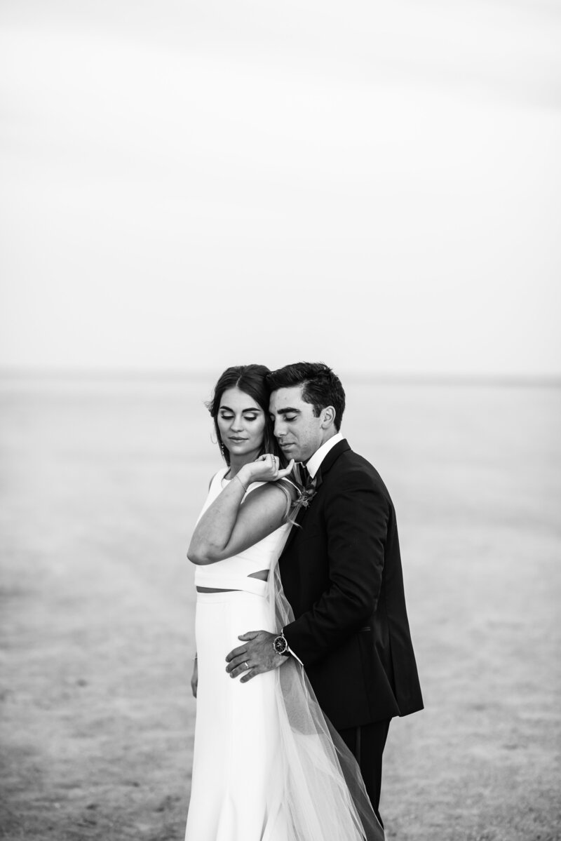 Luxury Wedding Portraits by Moving Mountains Photography in NC - Photo of a couple on their wedding day on the beach.
