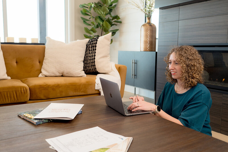 Client and agent sitting on couch reviewing home documents together