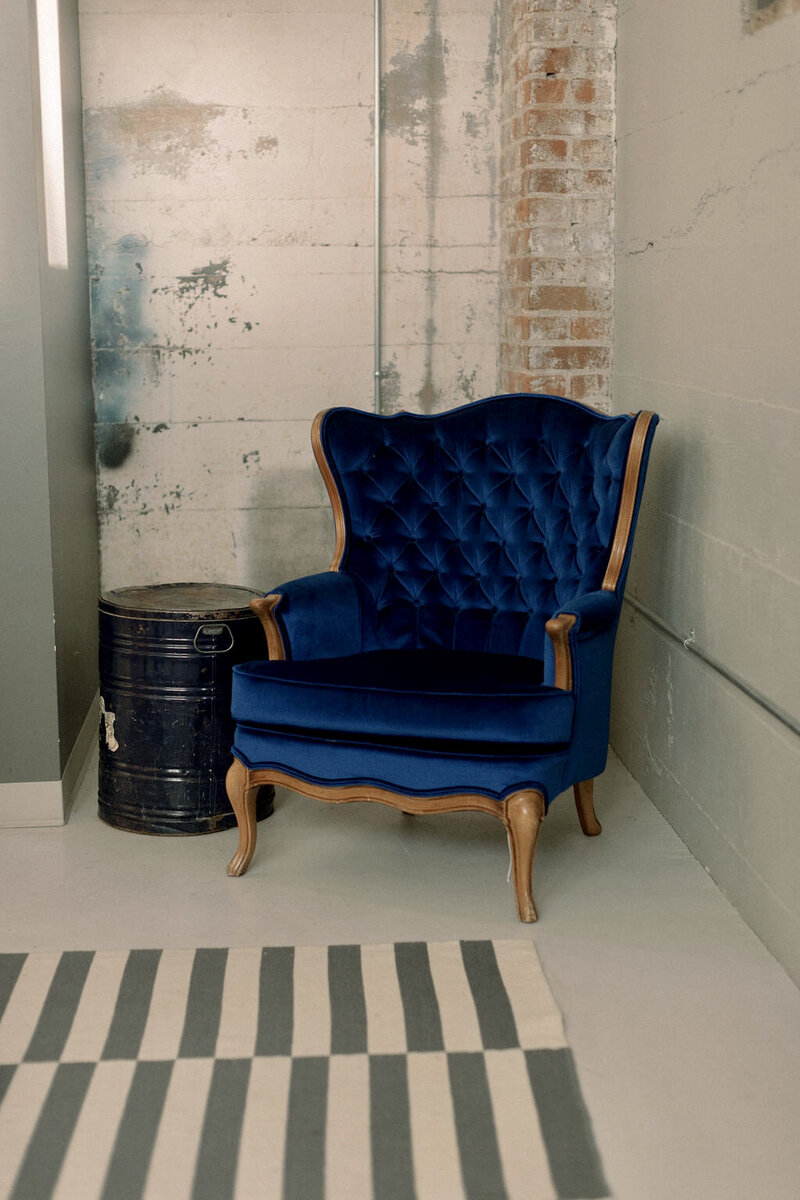 Blue vintage chair in the grooms room at the St Vrain wedding venue