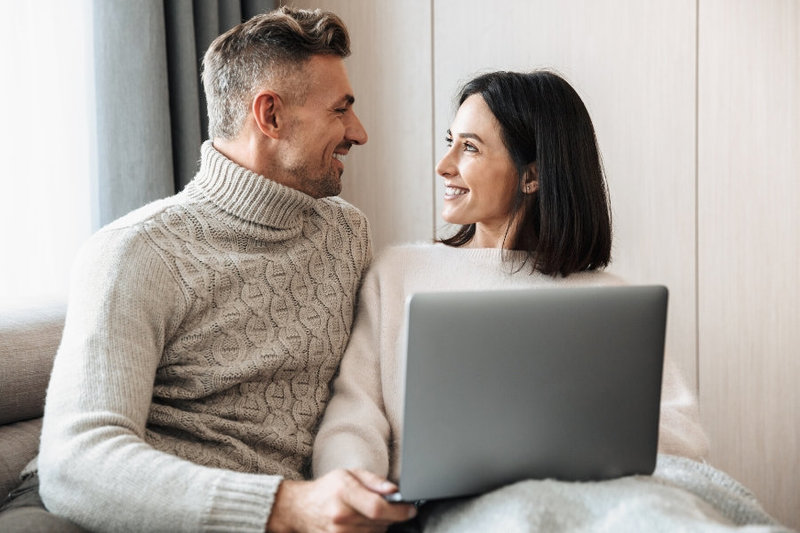 A couple smile warmly at one another as they hold a laptop as a part of their affair recovery program. This could symbolize the loving bond a couple can cultivate. We offer support when recovering from infidelity in Florida. Learn of our affair recovery program to begin recovering from infidelity.