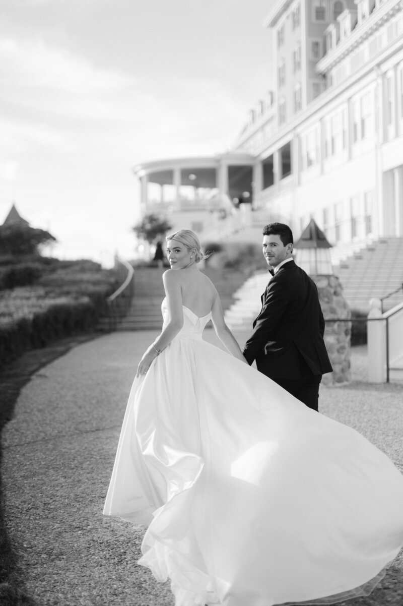 newlyweds walking in black and white