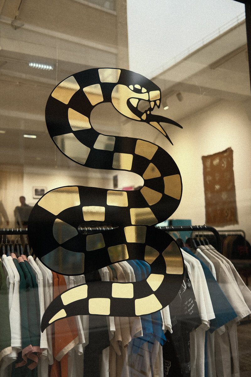 A snake graphic on the window of the P&Co Shoreditch Pop-Up Store.