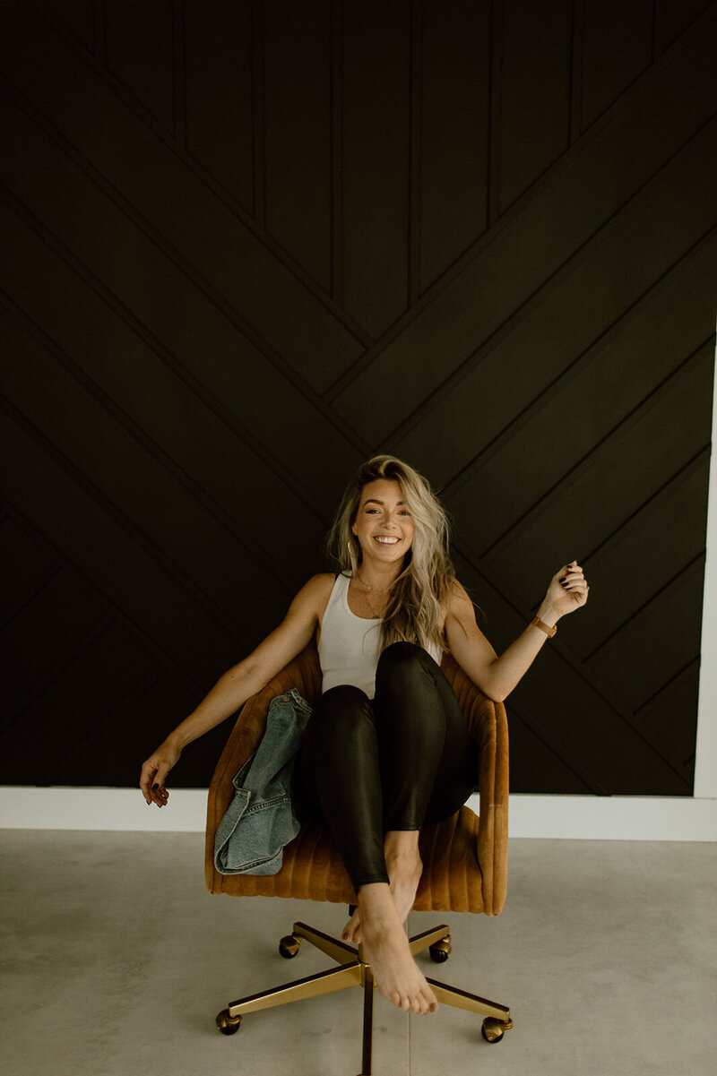 woman sitting in a chair smiling at camera