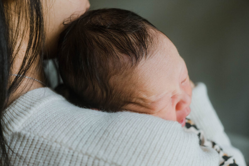 Closeup of newborn baby being held