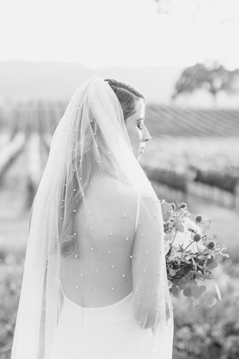 black and white image of bride with pearl beaded veil.