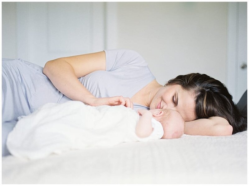 DC NeMother laying on bed with her baby during DC newborn photo session