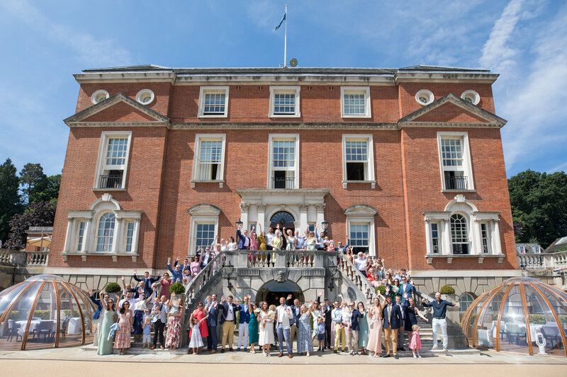 Wedding party and family on estate steps UK
