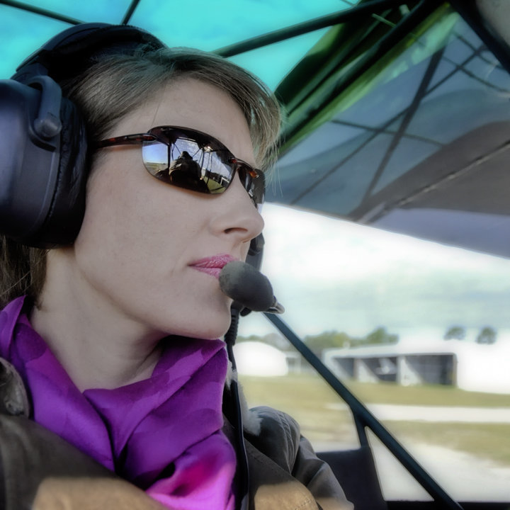 Lifestyle Photography Portrait of Erin Tetterton Photography by a small airplane