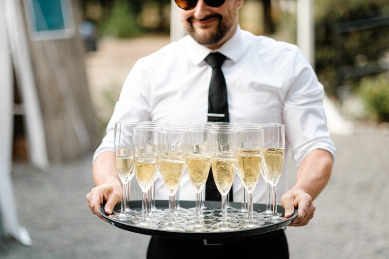 Server carries a tray of champagne