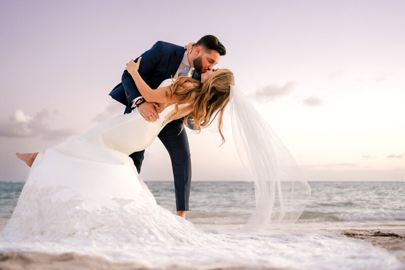 Luxury Wedding Portraits by Moving Mountains Photography in NC - Photo of a couple on their wedding day with an ocean view.