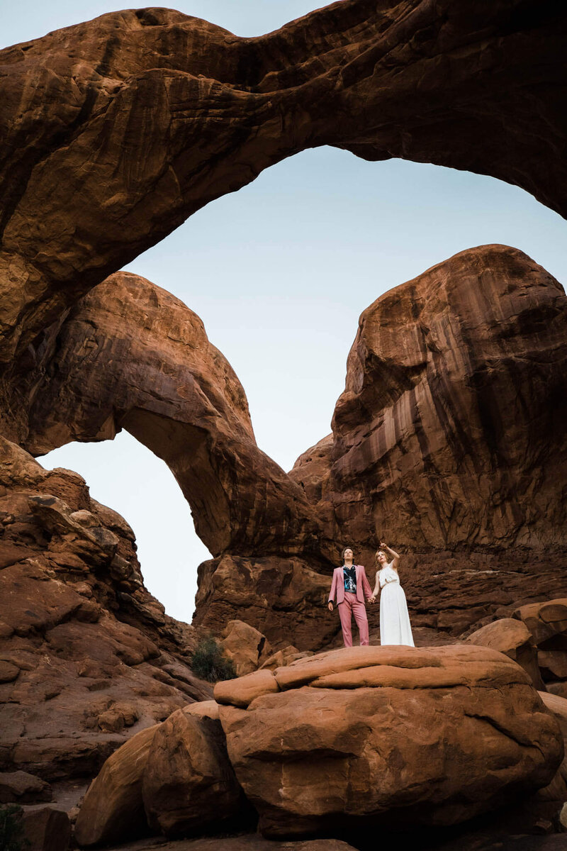With a storm in the distance the couple walks into the open desert during their elopement.