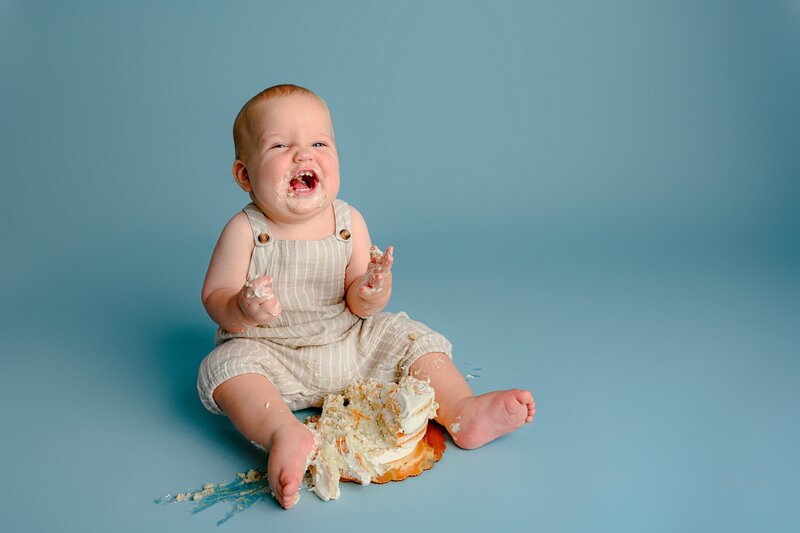 little boy plays in smashed cake for his simple smash studio session