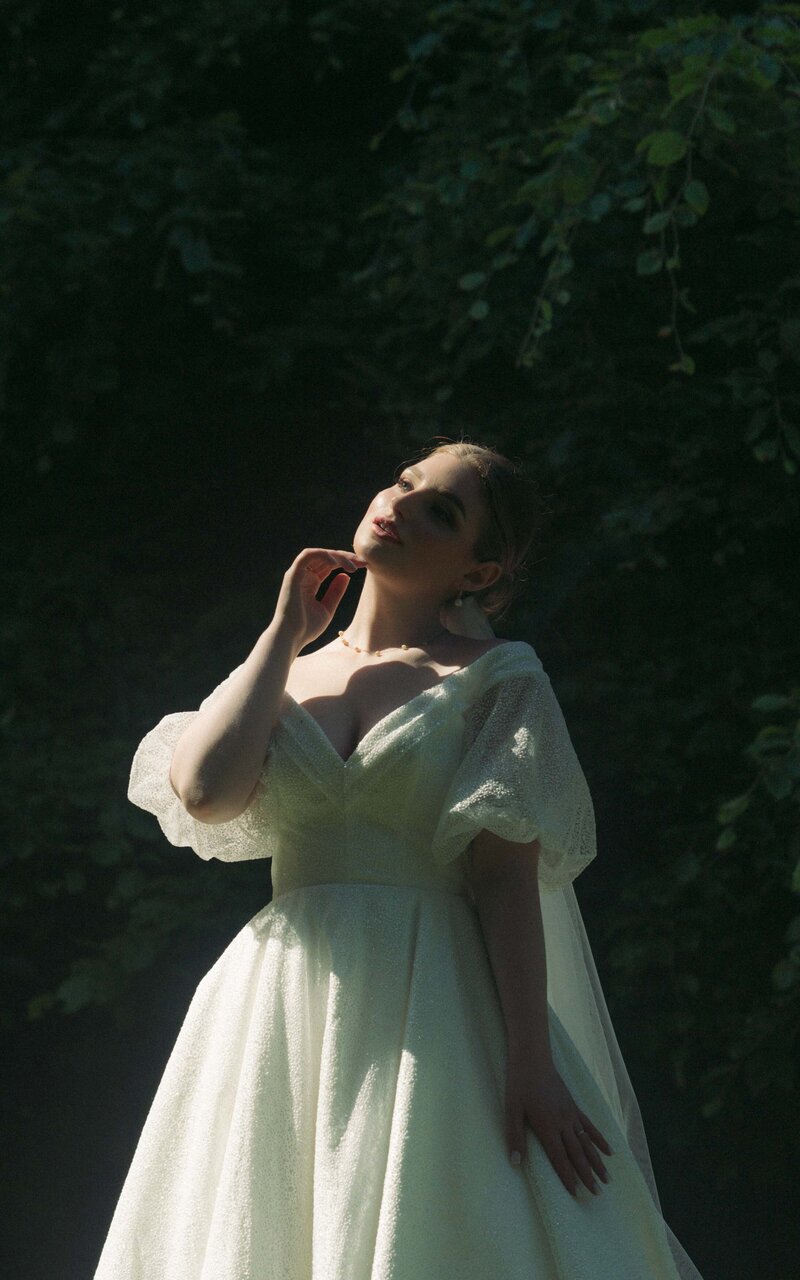Stunning bride elegantly posing in her wedding dress, showcasing beauty and grace in a captivating moment before the celebration begins, radiating love and joy