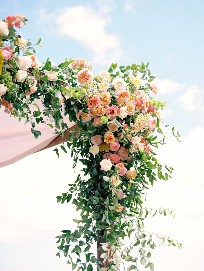 colorful coral and peach ceremony chuppah