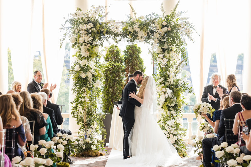 The newlywed couple share their first kiss at
