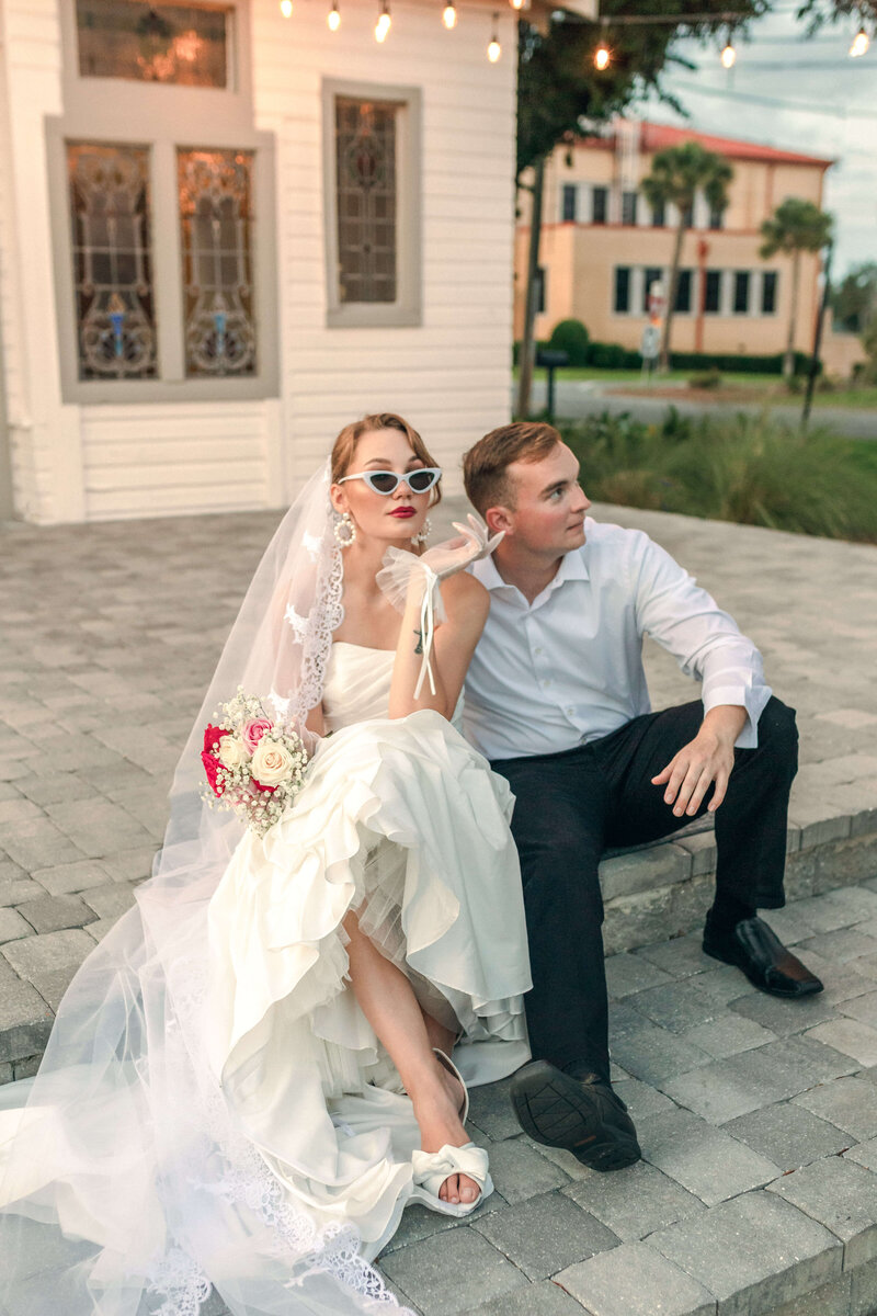 newlyweds sit on stoop of Sapp house in downtown panama city