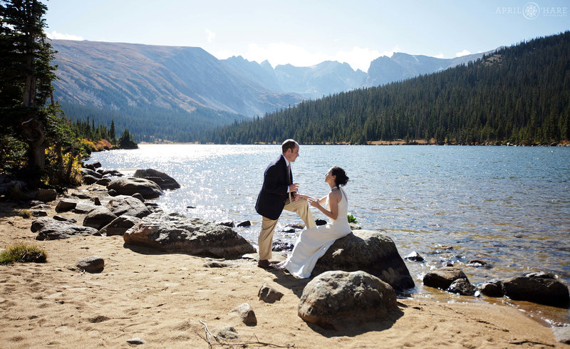 Couple celebrates lake side next to Long Lake at Indian Peaks Wilderness Area of Colorado