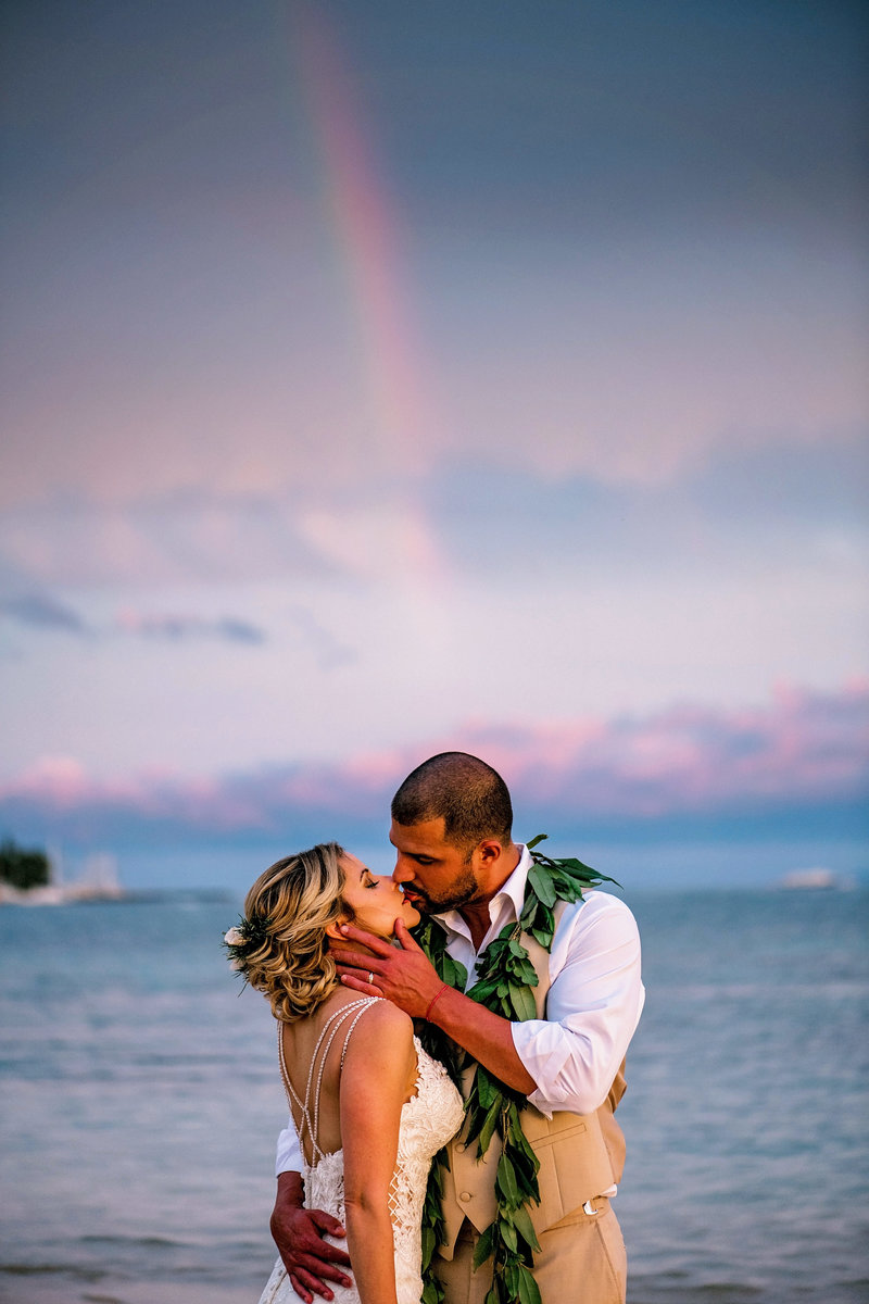 Couple kiss under a rainbow in Lahaina Maui