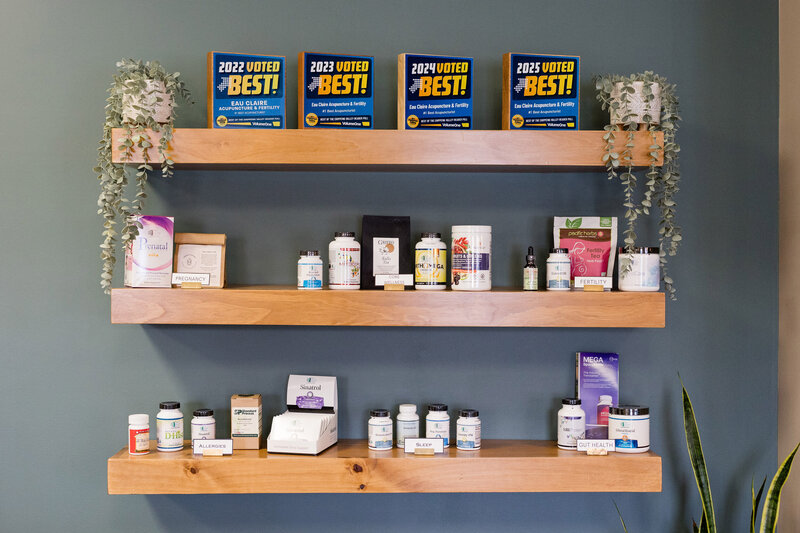 A row of 4 VolumeOne best of awards on a floating shelf