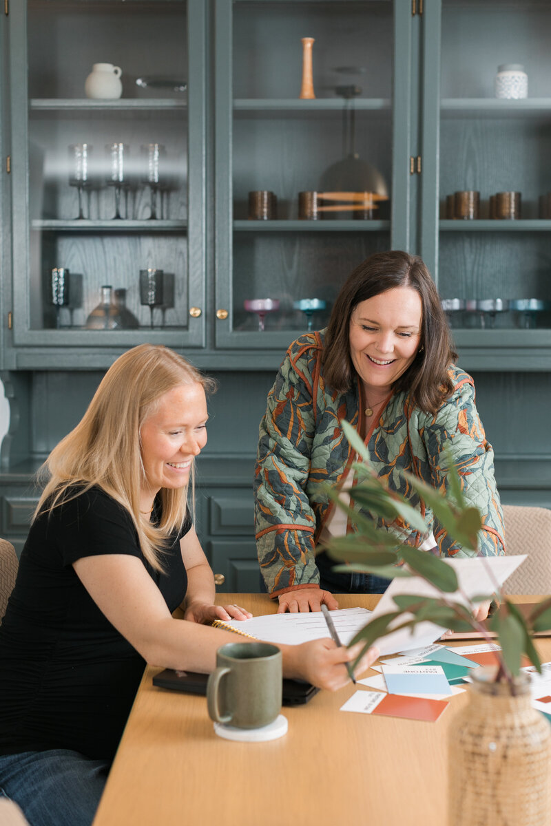two women working at a laptop