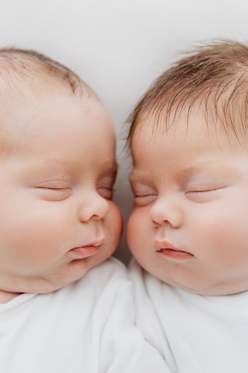 Happy new parents holding their sleeping baby on a photoshoot in Cheshire