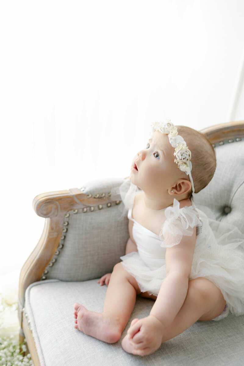 Baby sitting on bench taken by nj cake smash photographer