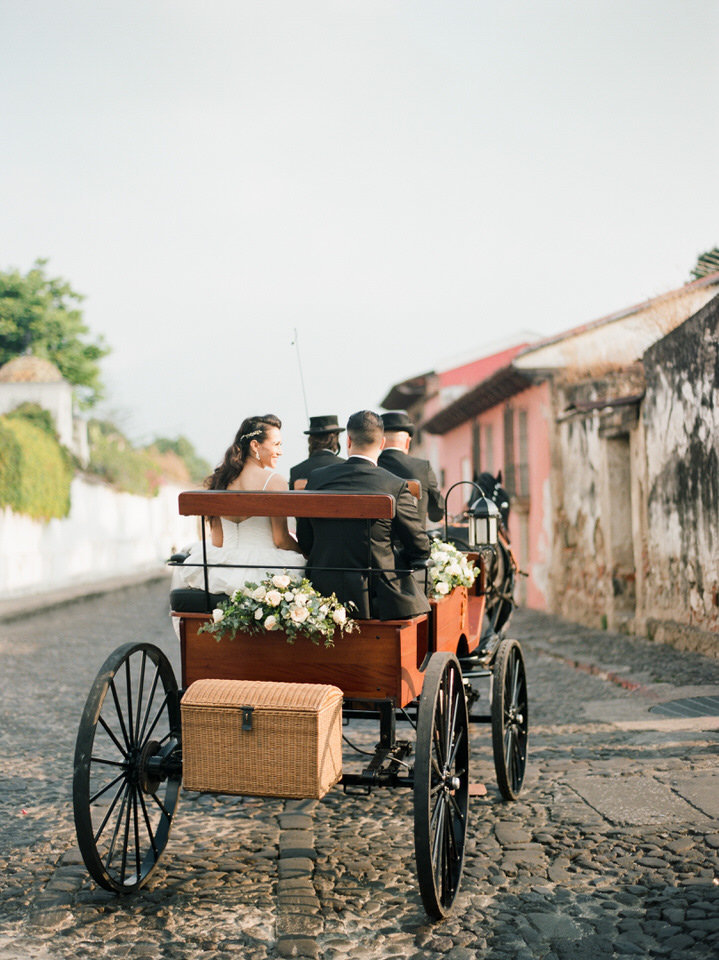 bride and groom in a horse drawn carriage